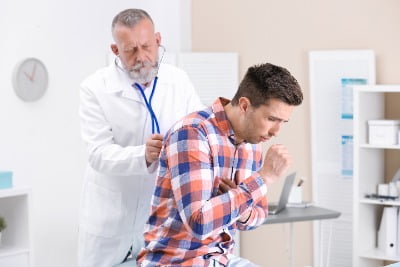Man suffering from respiratory problems coughing